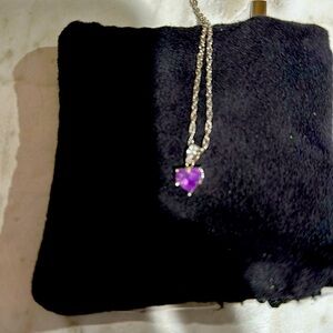 Amethyst heart pendant set in 10k white gold with sterling sliver rope chain.